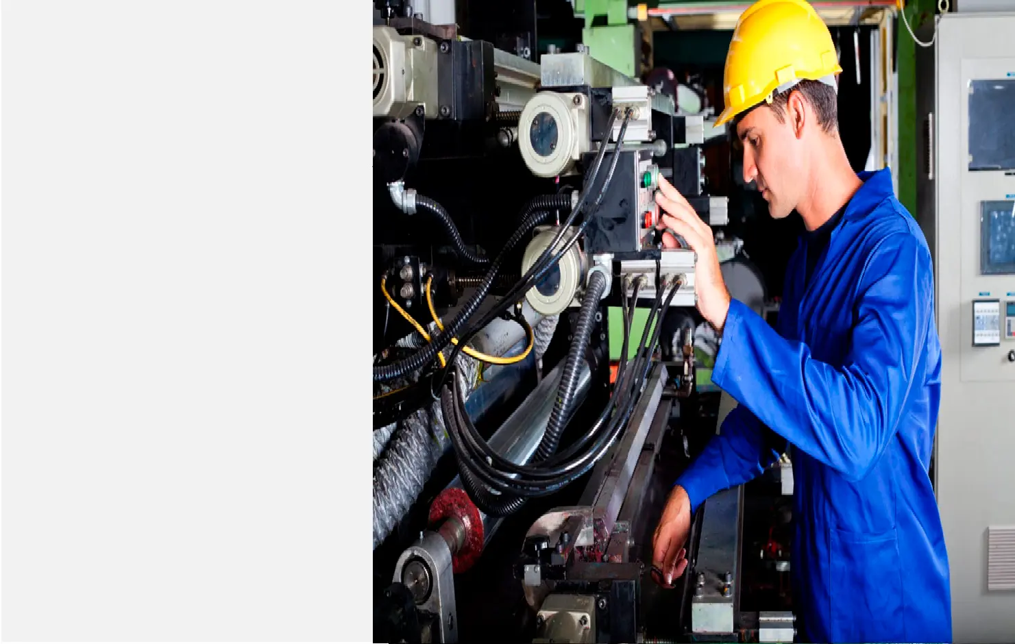 Engineer in a hard hat servicing industrial equipment