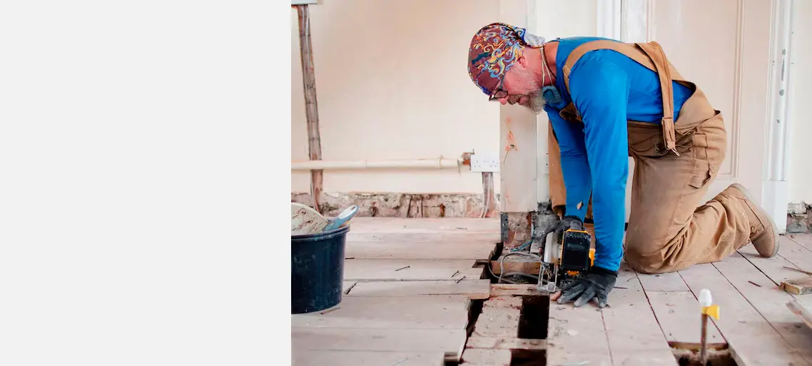 Worker repairing a floor