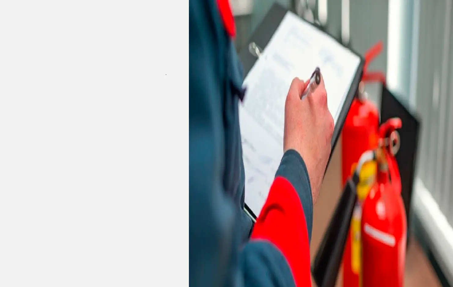Inspector with a tablet next to a fire extinguisher