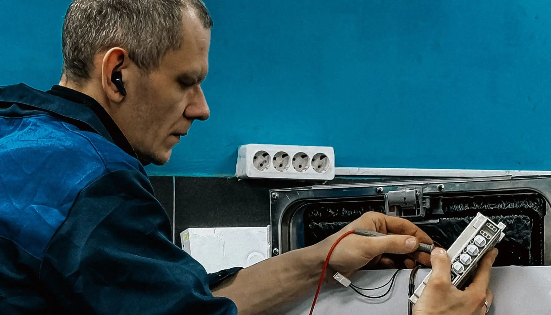 Service technician repairing a home appliance on site